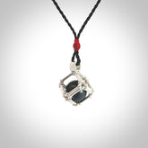 Black Jade round ball carving in Sterling Silver surround box. Hand carved for NZ Pacific. Handmade jewellery for sale online. The cord is a 3-braid plait in black and is adjustable. Black Jade necklace for men and women. Heart necklace hand made from Black Jade and sterling silver.